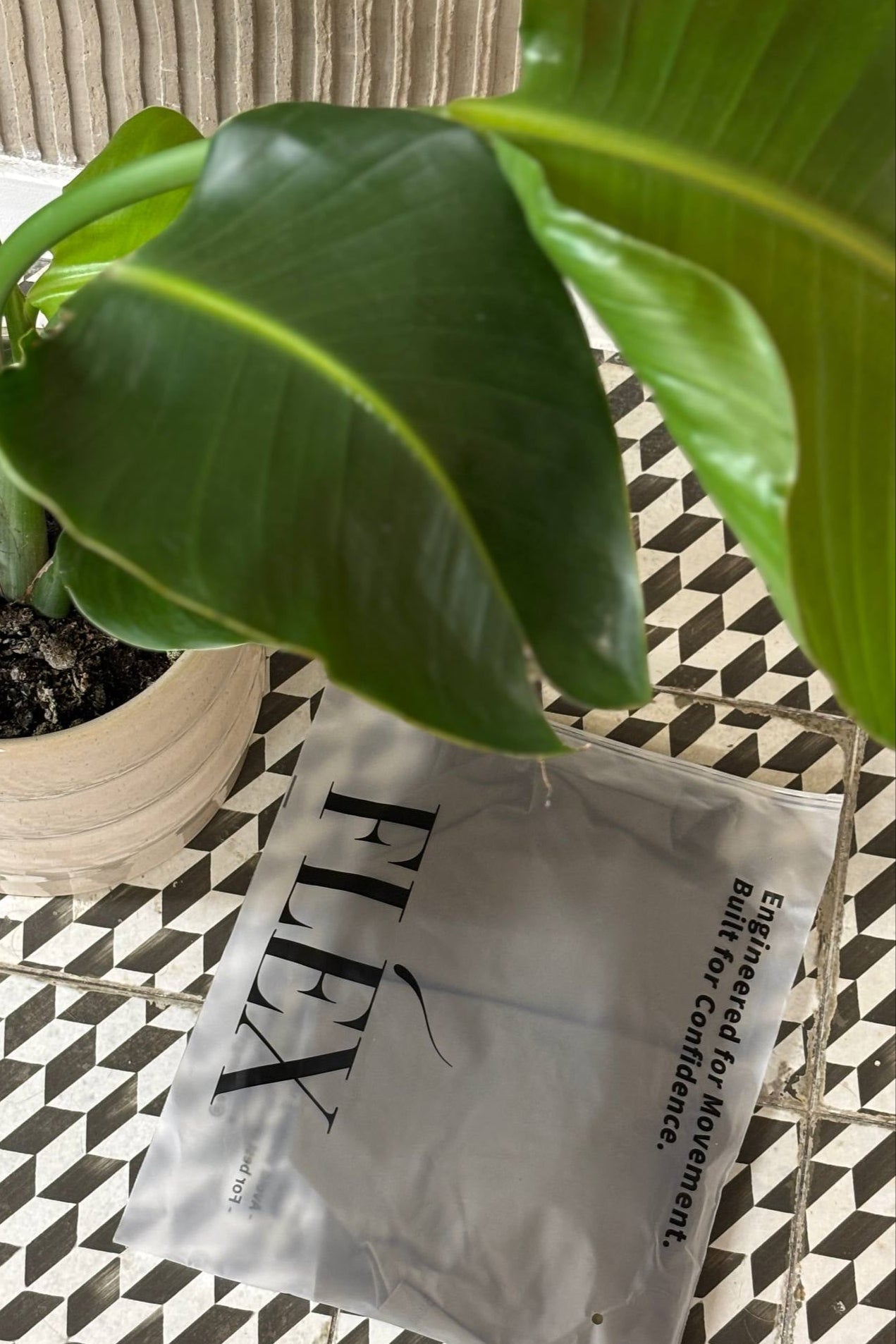 White sachet with black text on a patterned floor