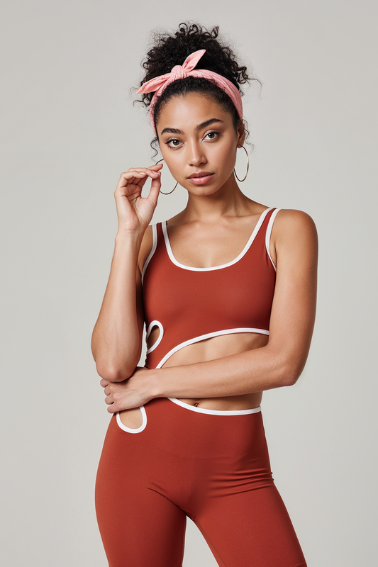 Woman wearing a red sports bra and shorts set on a plain background